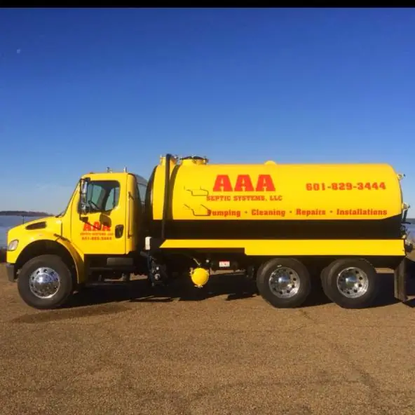 AAA Septic Systems branded yellow truck showing services and phone number